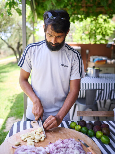 Yoga retreat leader cooking food for his guests
