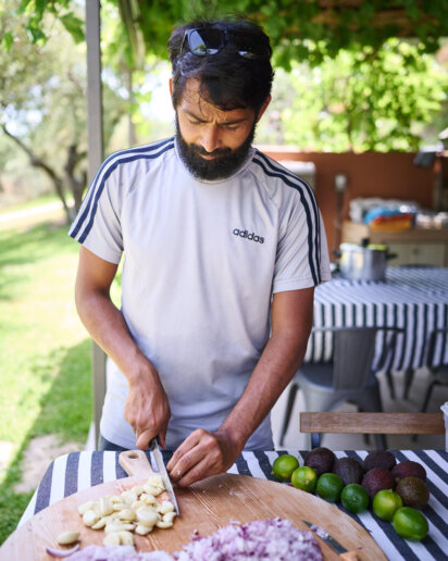 Yoga retreat leader cooking food for his guests