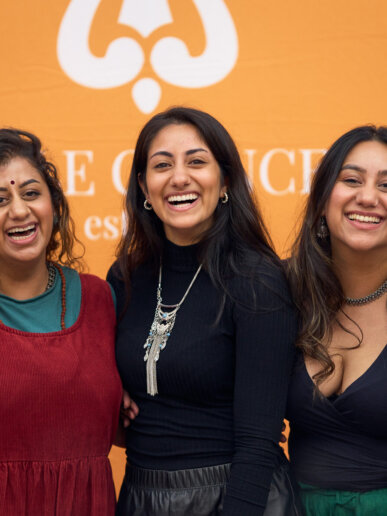 Exhibitors posing and having fun at their stand, great moment captured by the event photographer