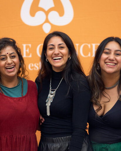 Exhibitors posing and having fun at their stand, great moment captured by the event photographer