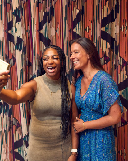 Olympic winner holding a Samsung flip phone during an event