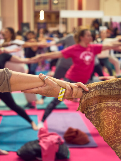 holding hands during a yoga festival show