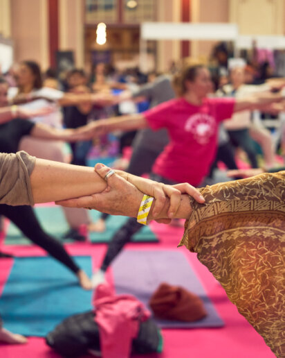 holding hands during a yoga festival show