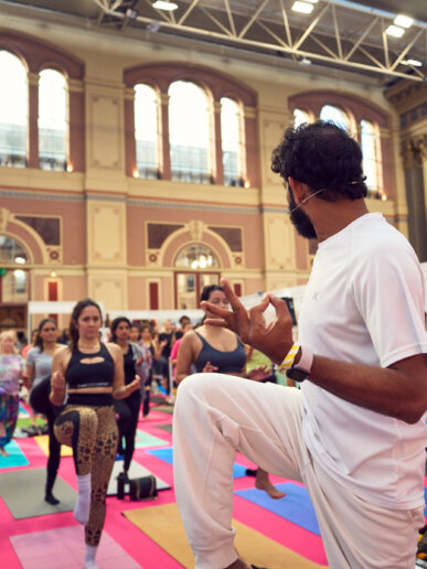 Yoga instructor leading session on stage at UK wellness festival