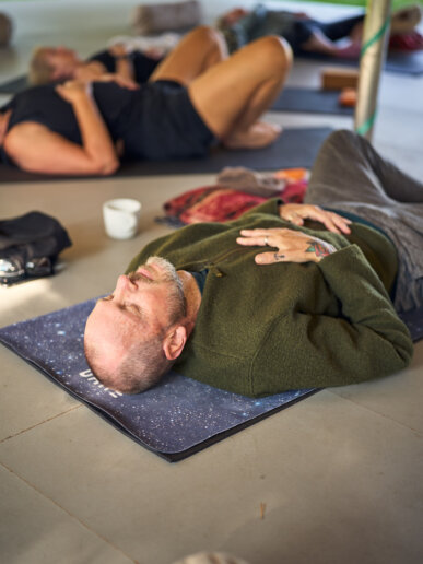 Man in a yoga pose during a yoga retreat