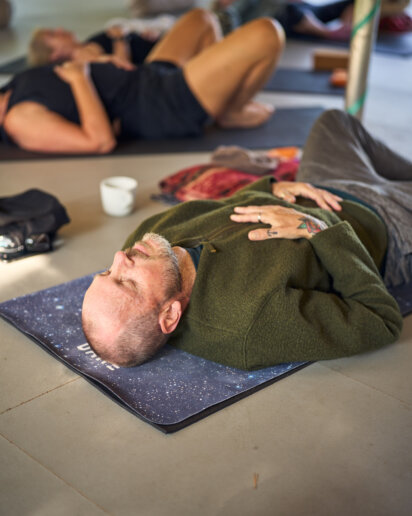 Man in a yoga pose during a yoga retreat