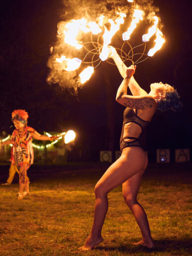 Girl with fire at a yoga festival