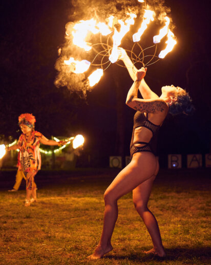 Girl with fire at a yoga festival