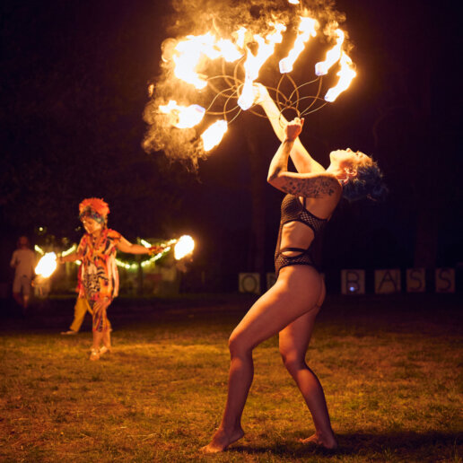Girl with fire at a yoga festival